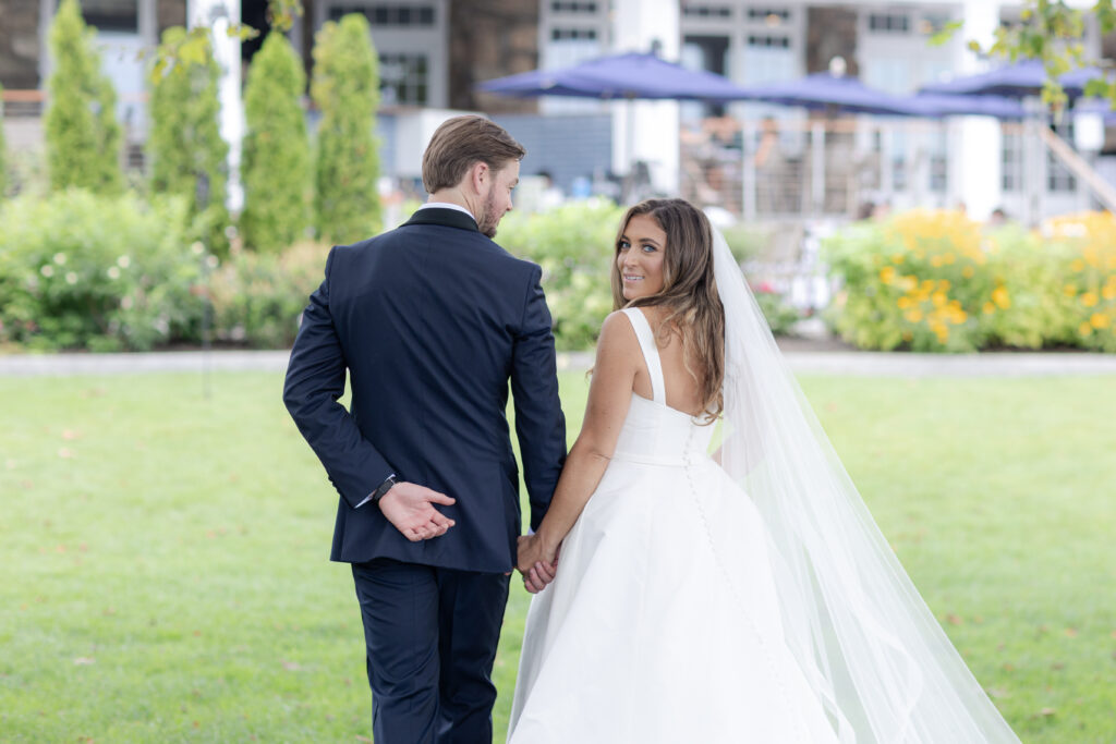 Bride and groom portraits  on the grass in front of clubhouse wedding venue