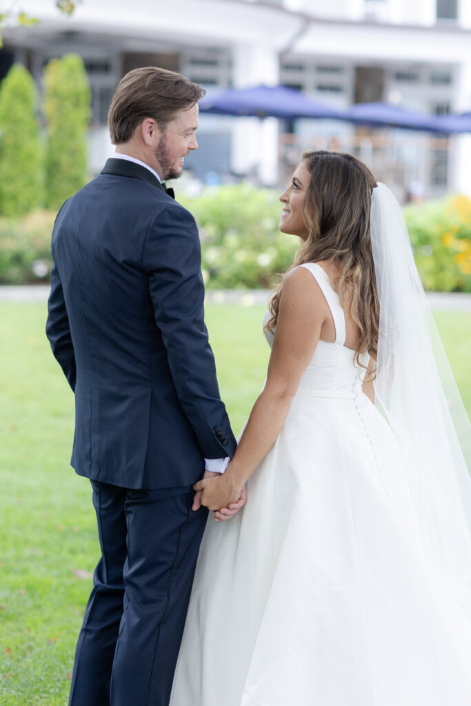 Bride and groom portraits  on the grass in front of clubhouse wedding venue