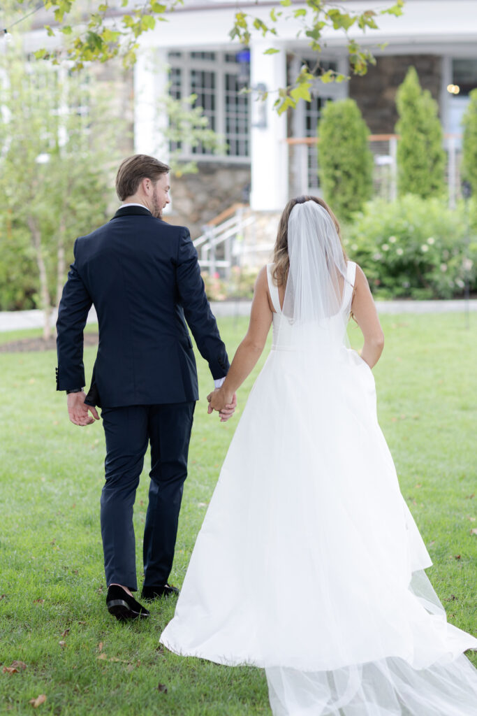 Bride and groom portraits  on the grass in front of clubhouse wedding venue