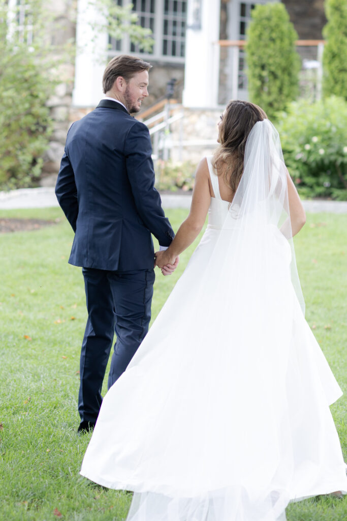 Bride and groom portraits on the grass in front of clubhouse wedding venue