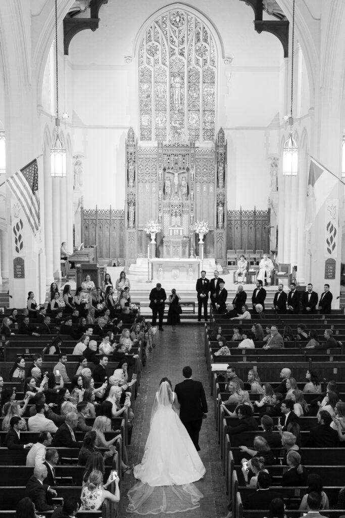 Bride walking down the aisle inside church for wedding ceremony