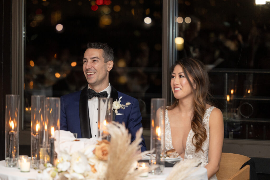 Bride and groom reacting to wedding speeches at Brooklyn wedding venue