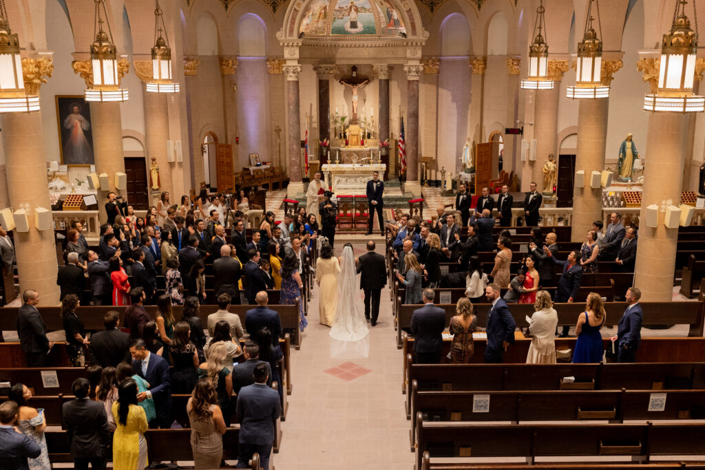 Bride walking down the aisle inside St. John Nepomucene Church in Manhattan, NYC