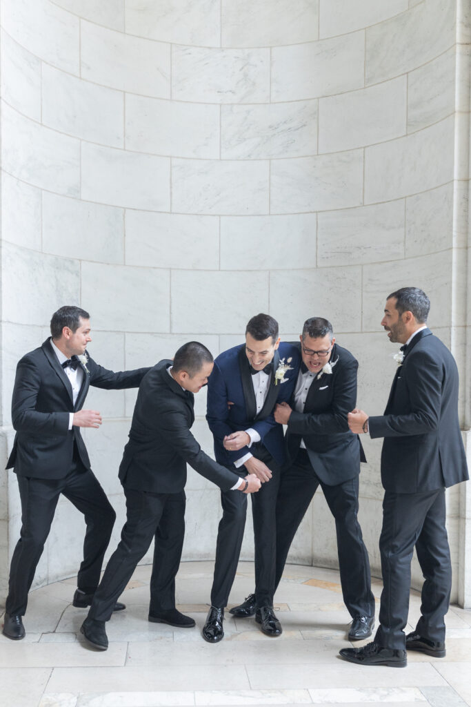 Groom and groomsmen portrait outside the NY Public Library