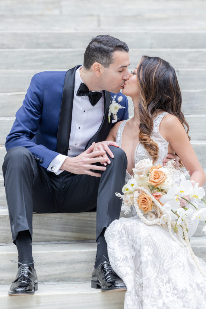 Bride and groom on the white steps outside of New York Public Library