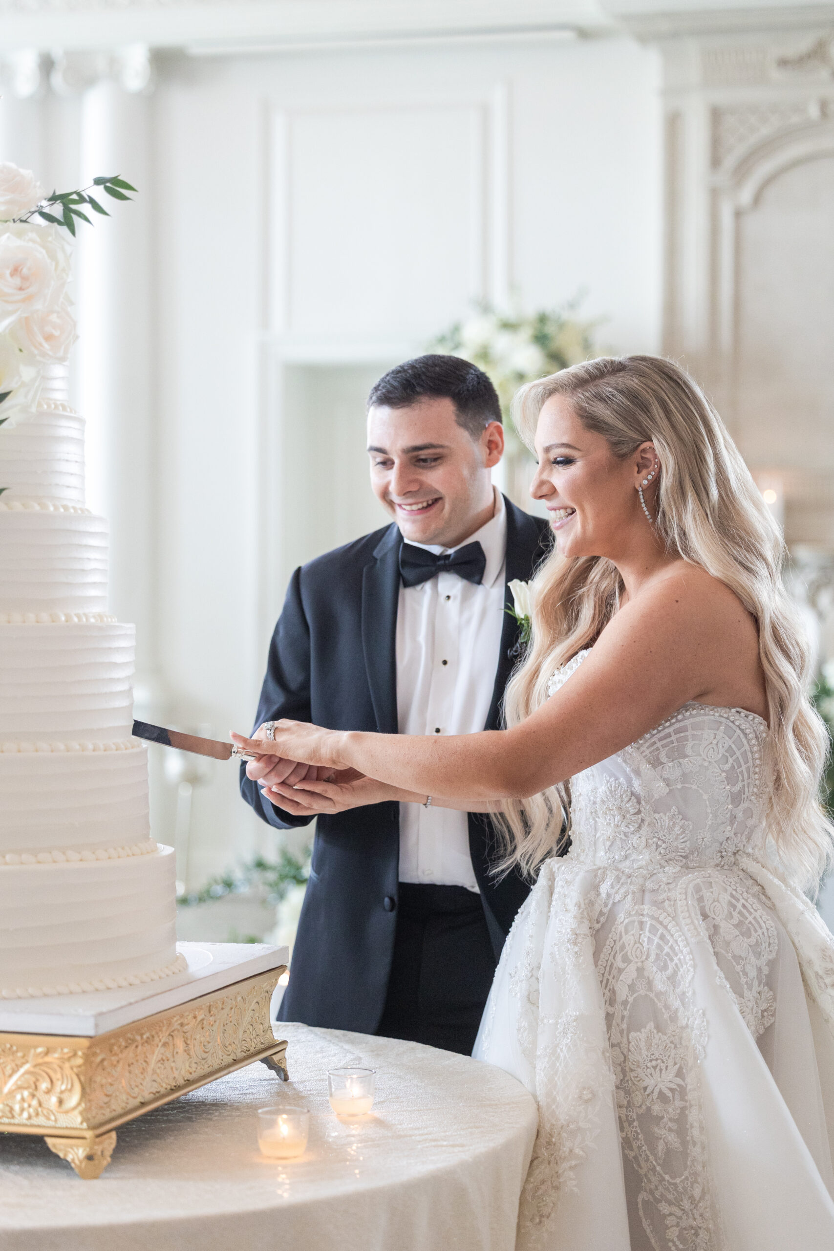 Bride and groom cutting cake at wedding reception 