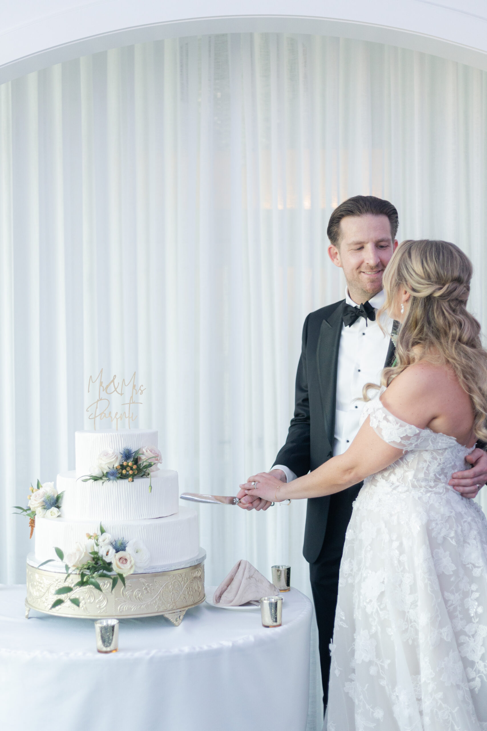 Bride and Groom Cake-Cutting Inside Wedding Reception