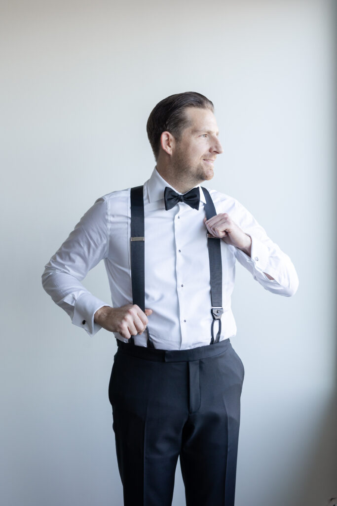 Groom Getting Ready_Suspenders Shot_Inside of Yacht Club Wedding Venue