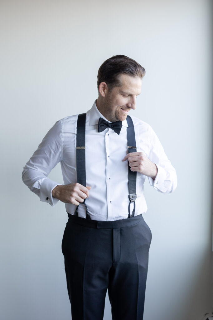 Groom Getting Ready_Suspenders Shot_Inside of Yacht Club Wedding Venue