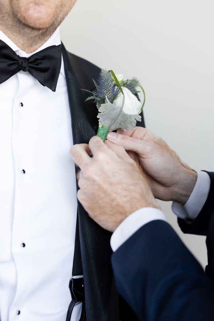 Groom Getting Ready_Boutonniere_Inside of Yacht Club Wedding Venue