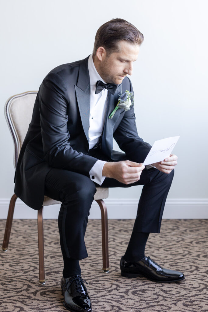 Groom Getting Ready_Reading Vows_Inside of Yacht Club Wedding Venue