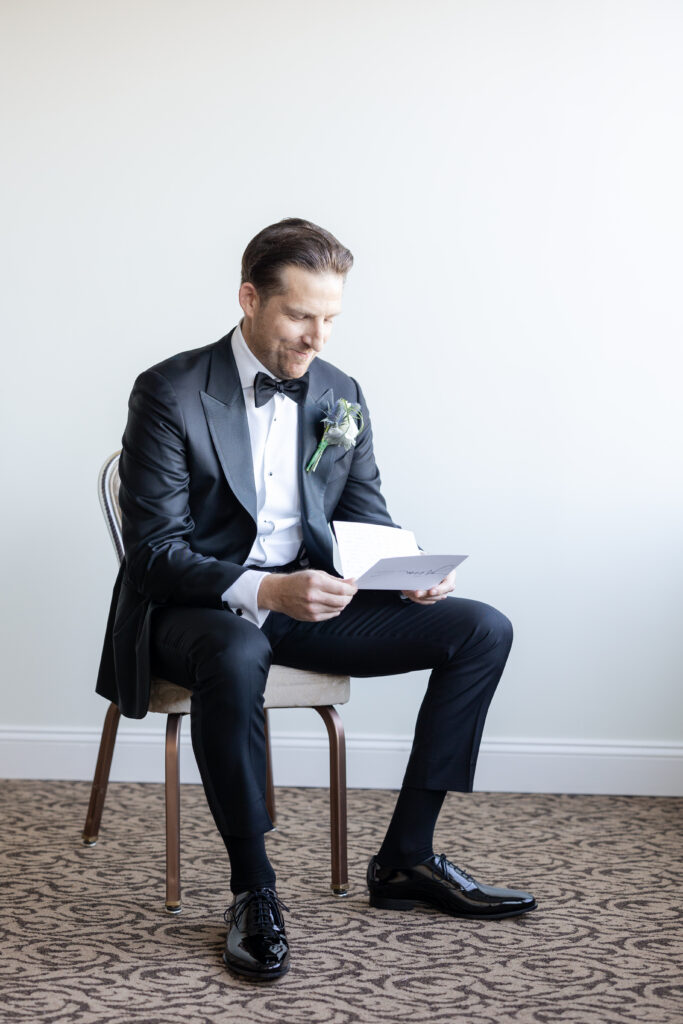 Groom Getting Ready_Reading Vows_Inside of Yacht Club Wedding Venue