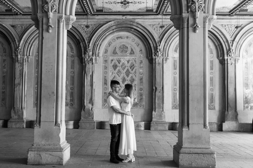 Black and White Engagement Session with couple in front of Central Park's Bethesda Terrace