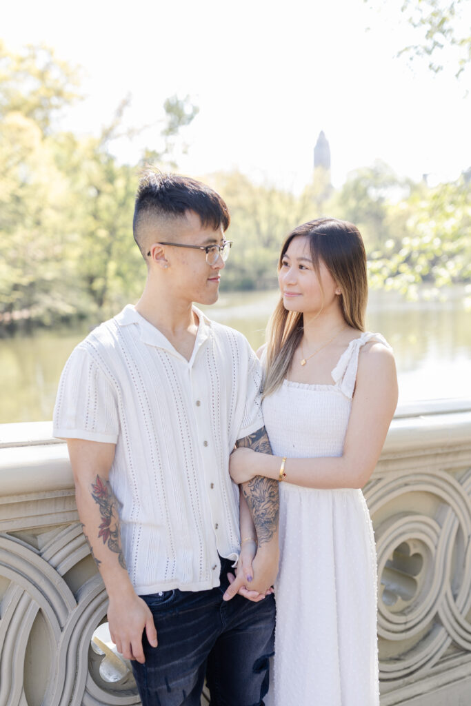 Couple on Bow Bridge against Waterview at Central Park