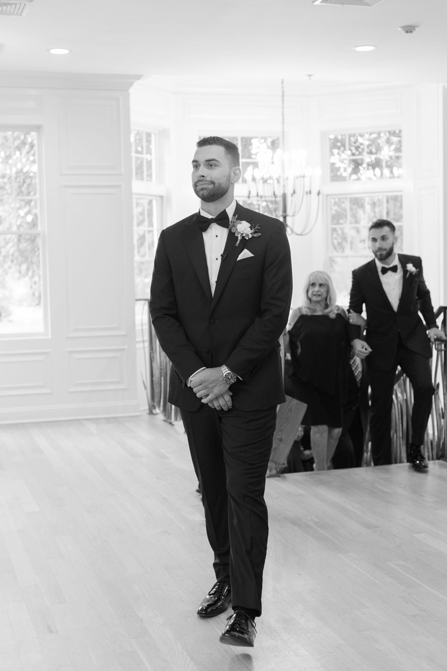 Black and White photo of Groom Walking Down Aisle inside NJ wedding venue