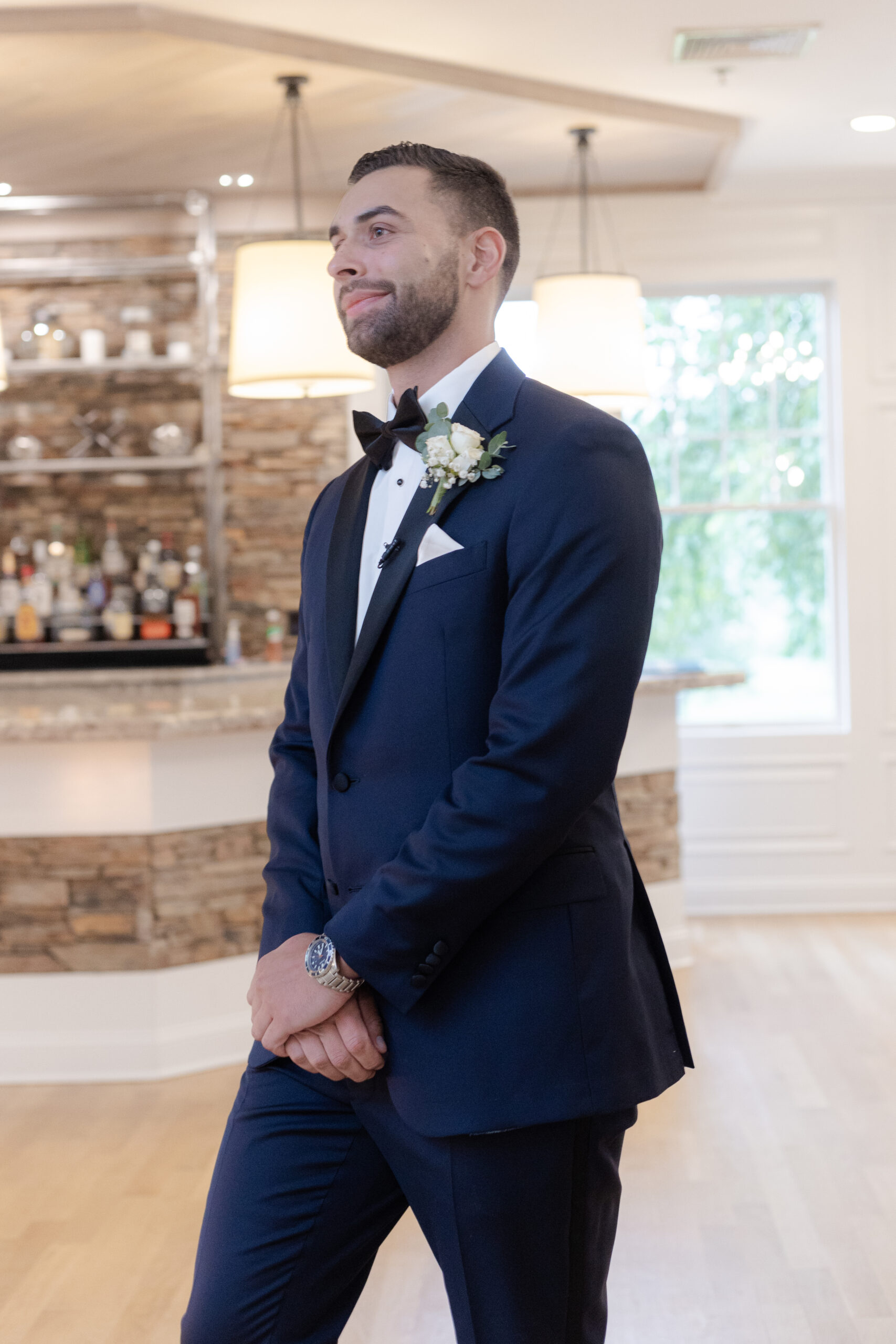 Wedding Ceremony Groom Walking Down Aisle inside Bear Brook Valley's indoor space