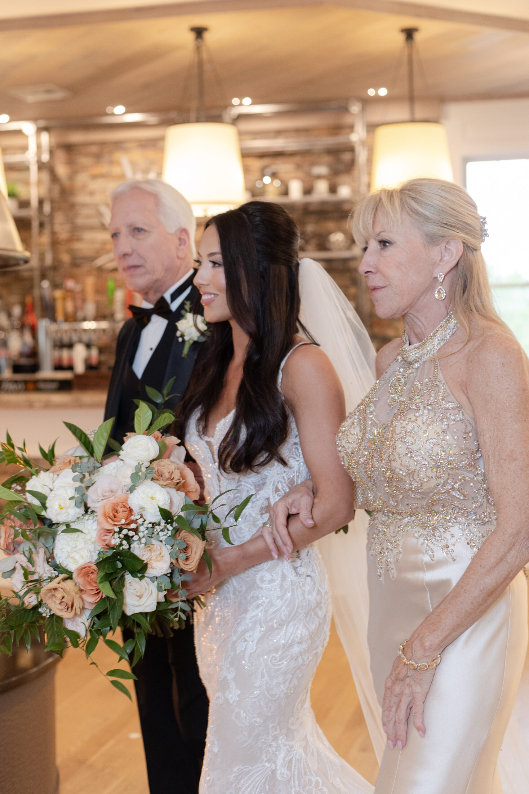 Bride Walking Down Aisle with Parents inside Bear Brook Valley venue