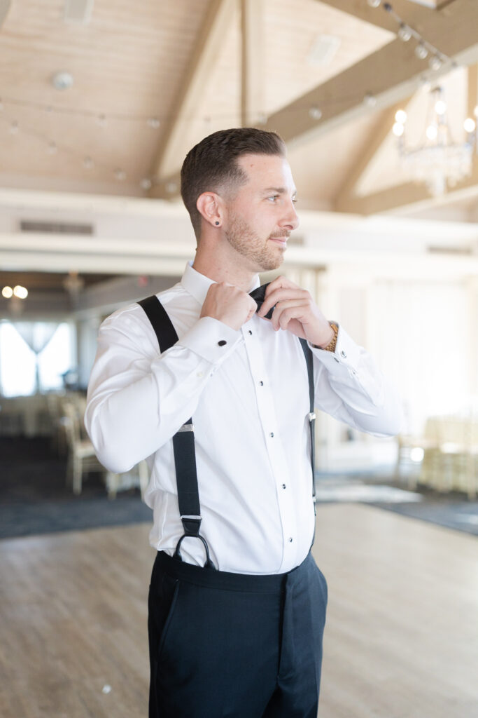 Groom getting ready at golf club wedding venue