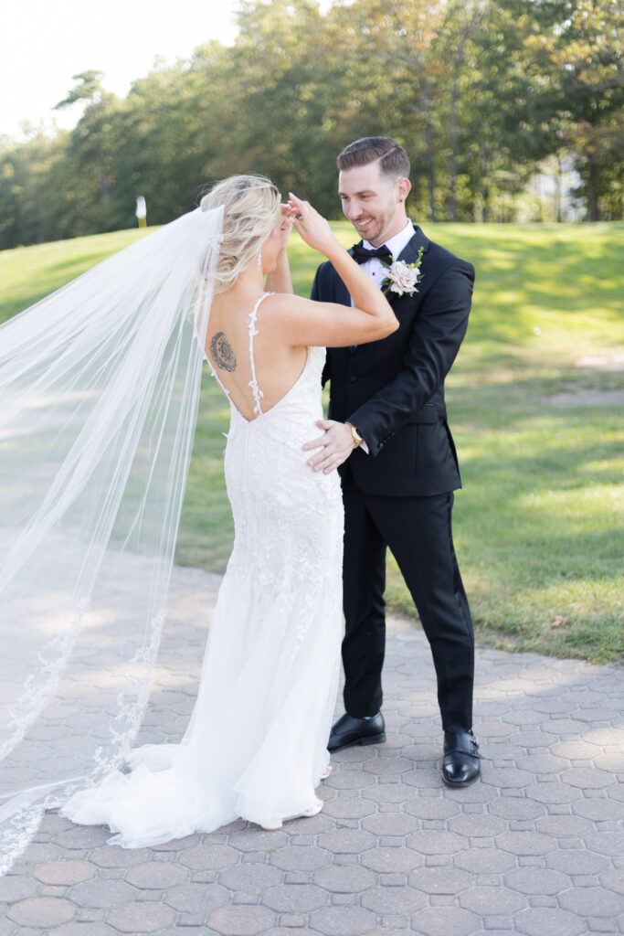 Bride and groom first look in front golf course