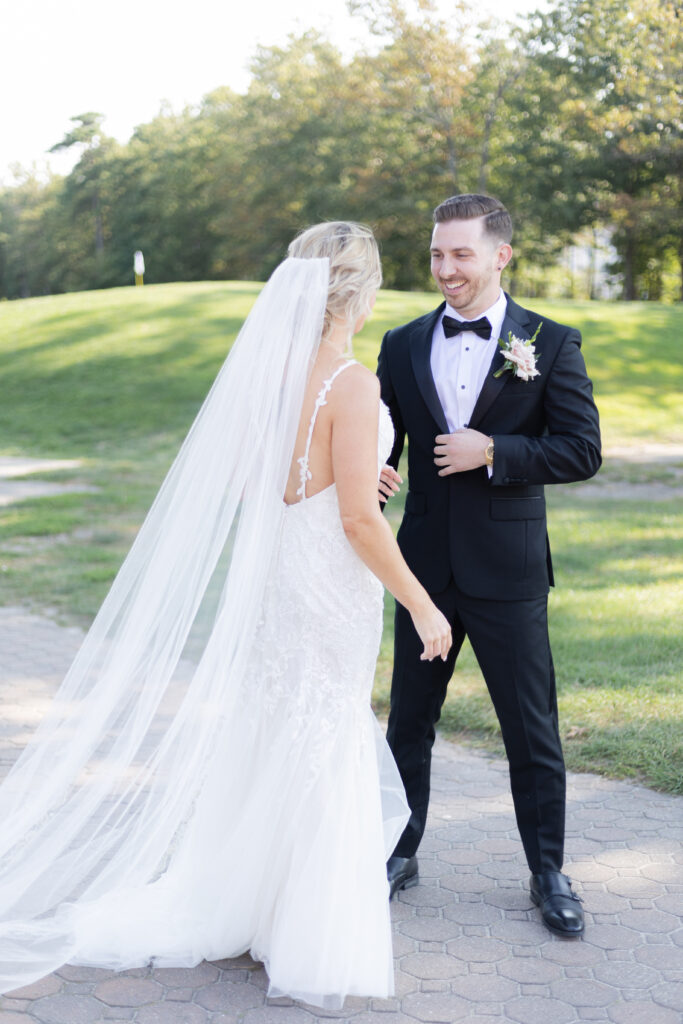 Bride and groom first look in front golf course