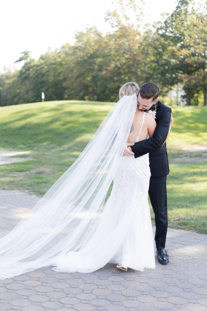 Bride and groom first look in front golf course