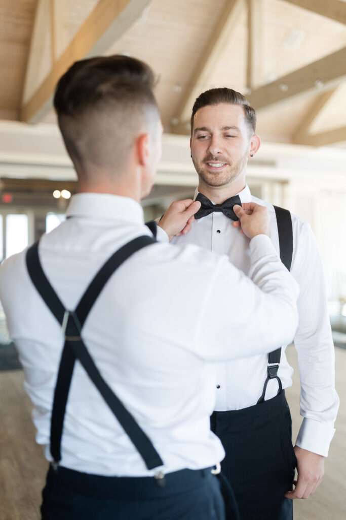 Groom getting ready with groomsmen at golf club wedding venue