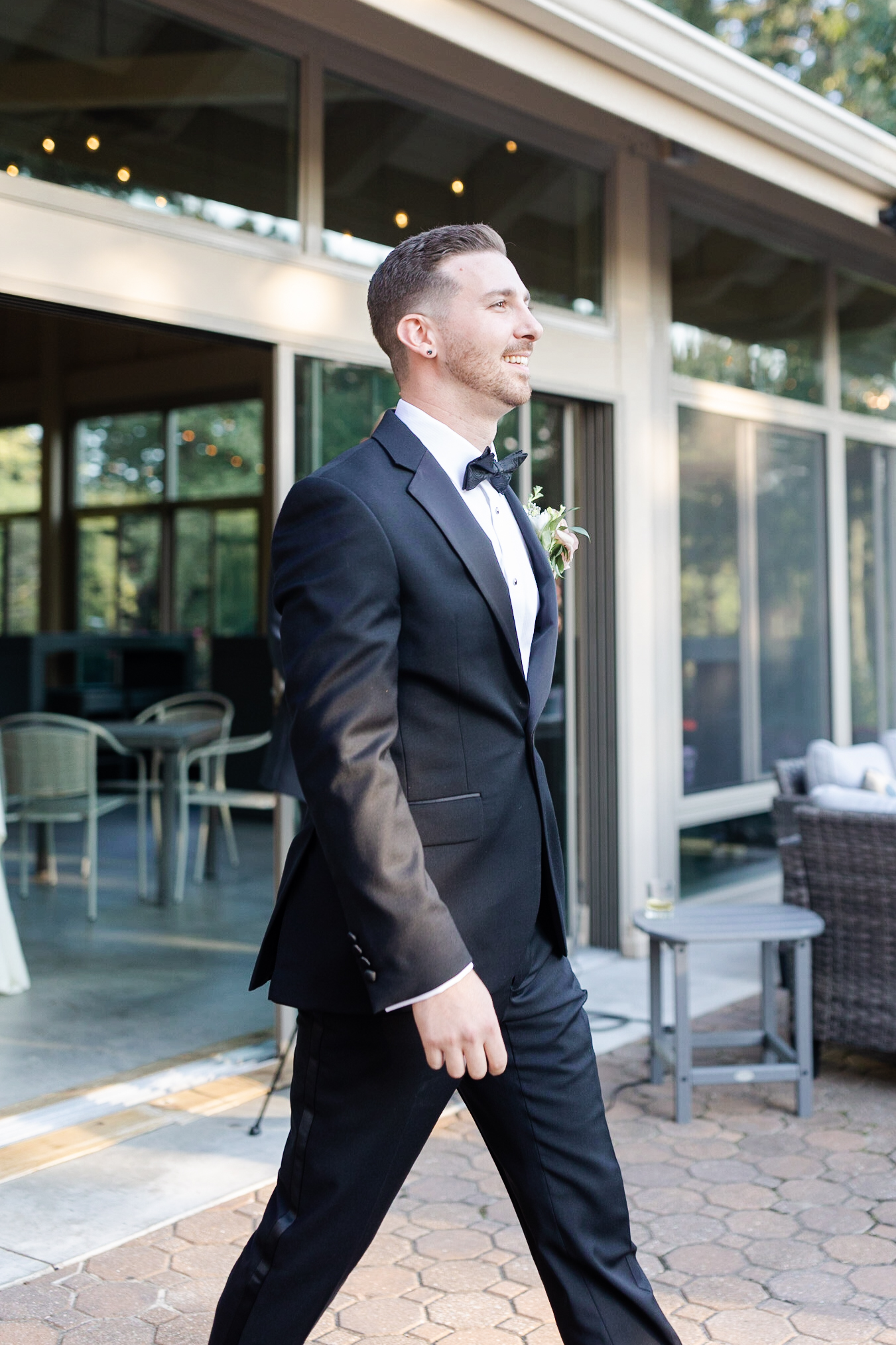 Groom walking in during wedding ceremony at golf course wedding venue