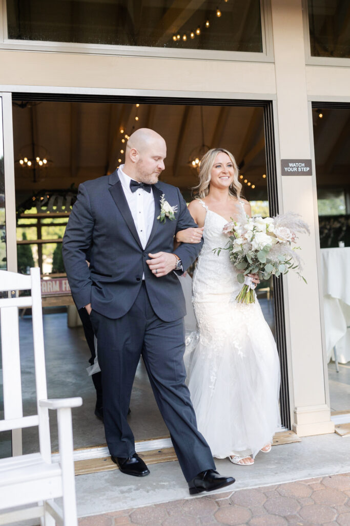 Bride and dad walking in during wedding ceremony at golf course wedding venue