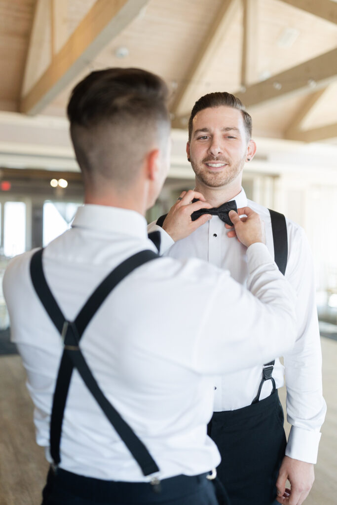 Groom getting ready with groomsmen at golf club wedding venue