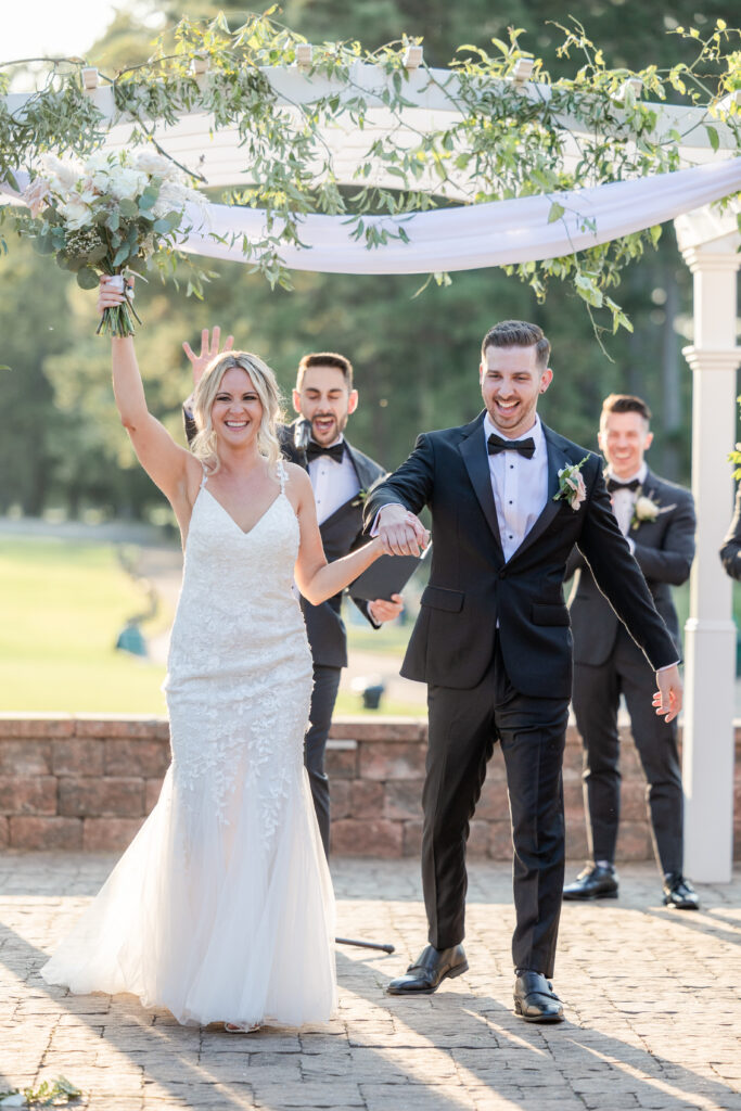 Bride and groom aisle walk during outdoor wedding ceremony