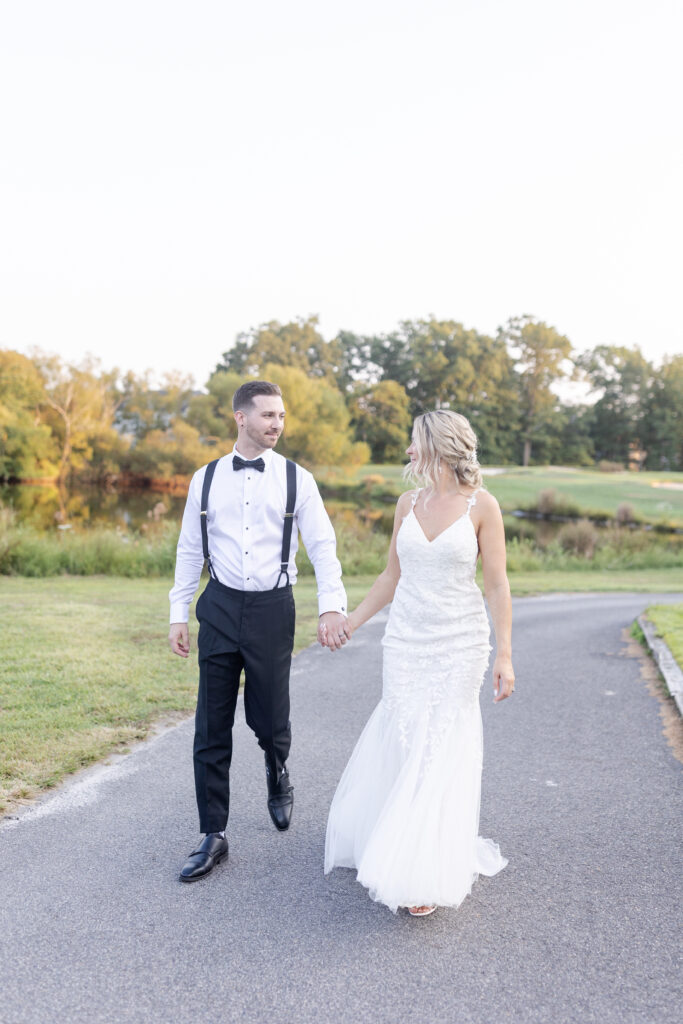 Bride and groom walking through golf club wedding venue