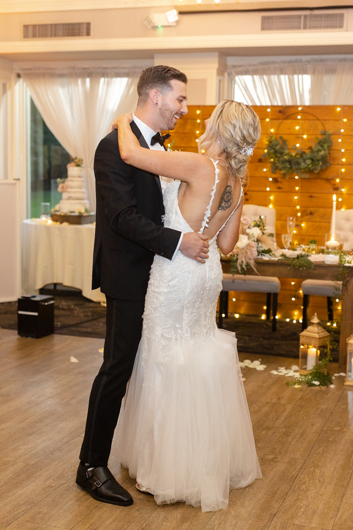 Bride and groom first dance inside golf club wedding venue