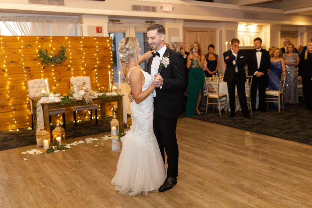 Bride and groom first dance inside golf club wedding venue