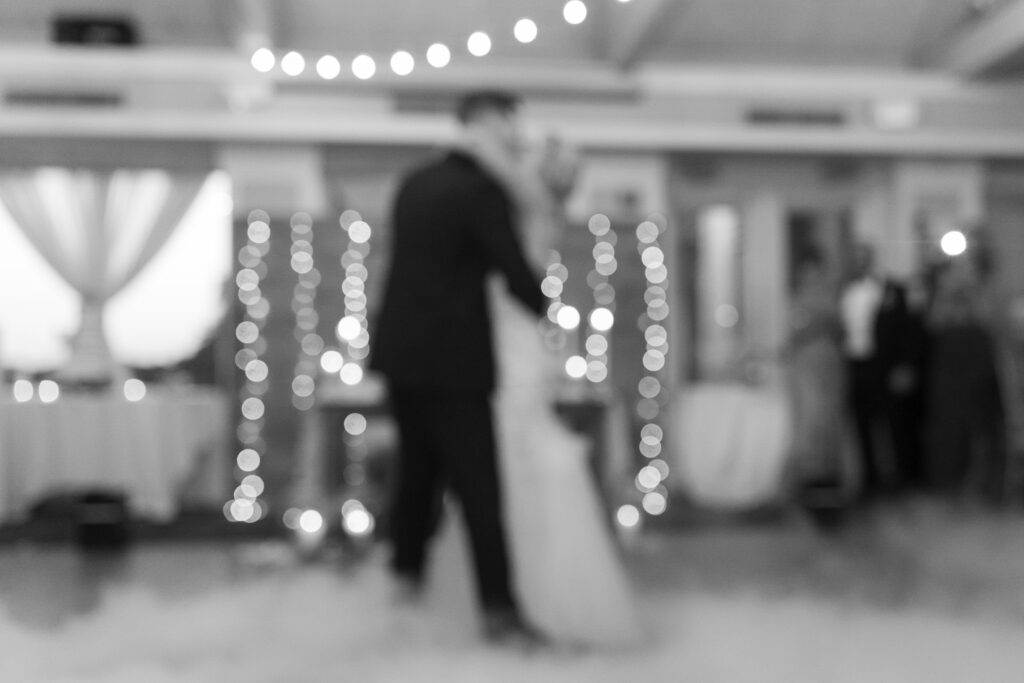 Bride and groom first dance inside golf club wedding venue