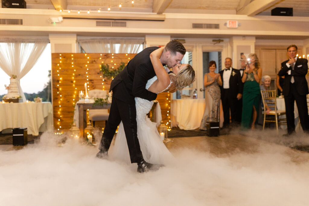 Bride and groom first dance inside golf club wedding venue