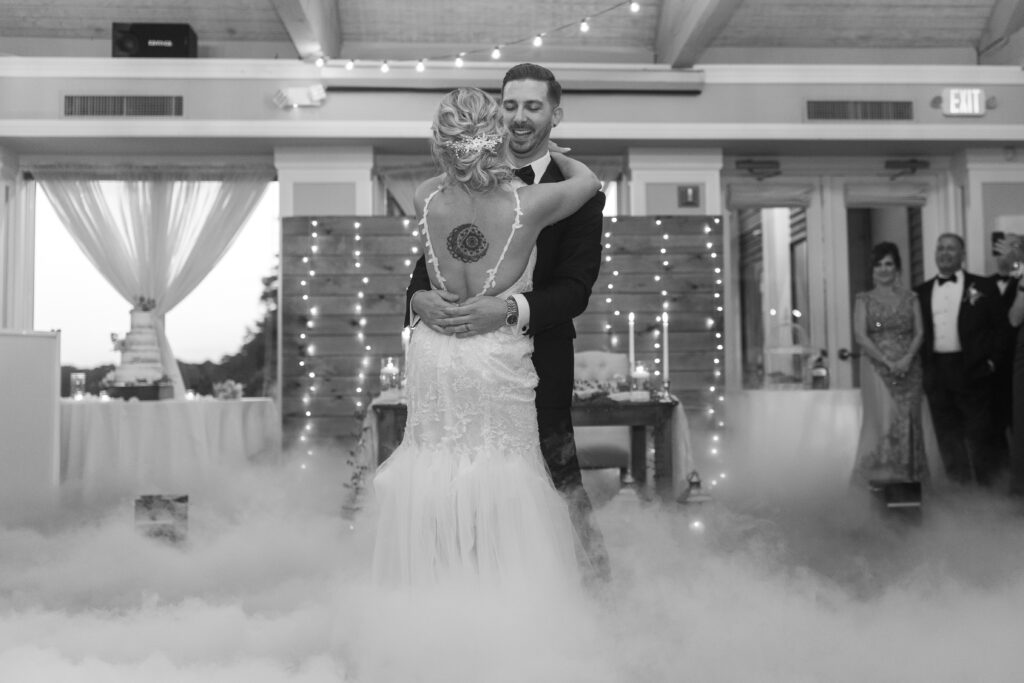 Bride and groom first dance inside golf club wedding venue