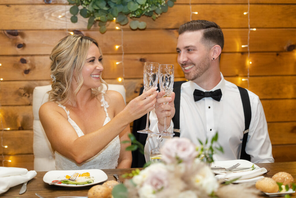 Bride and groom cheers in wedding reception