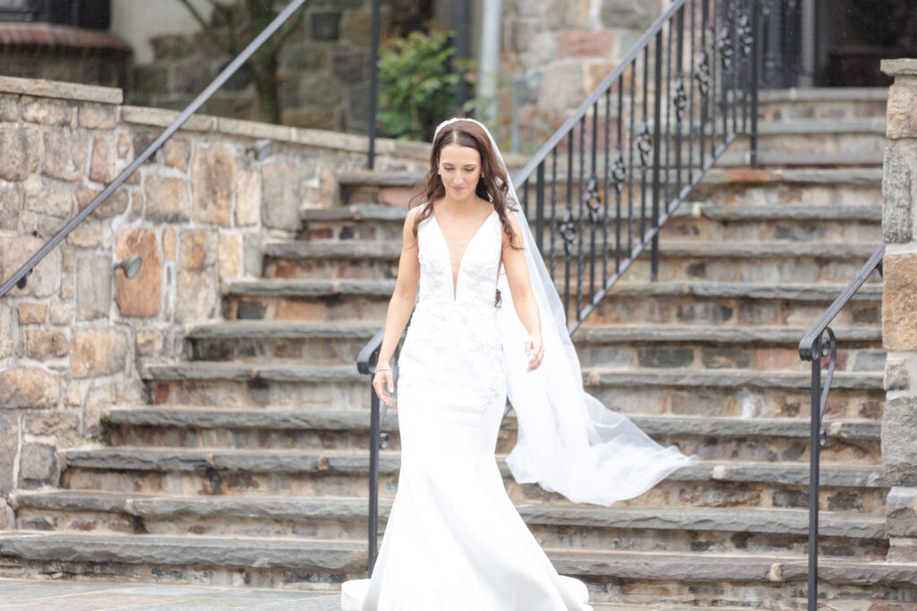 Bride walking towards groom outside of chateau wedding venue