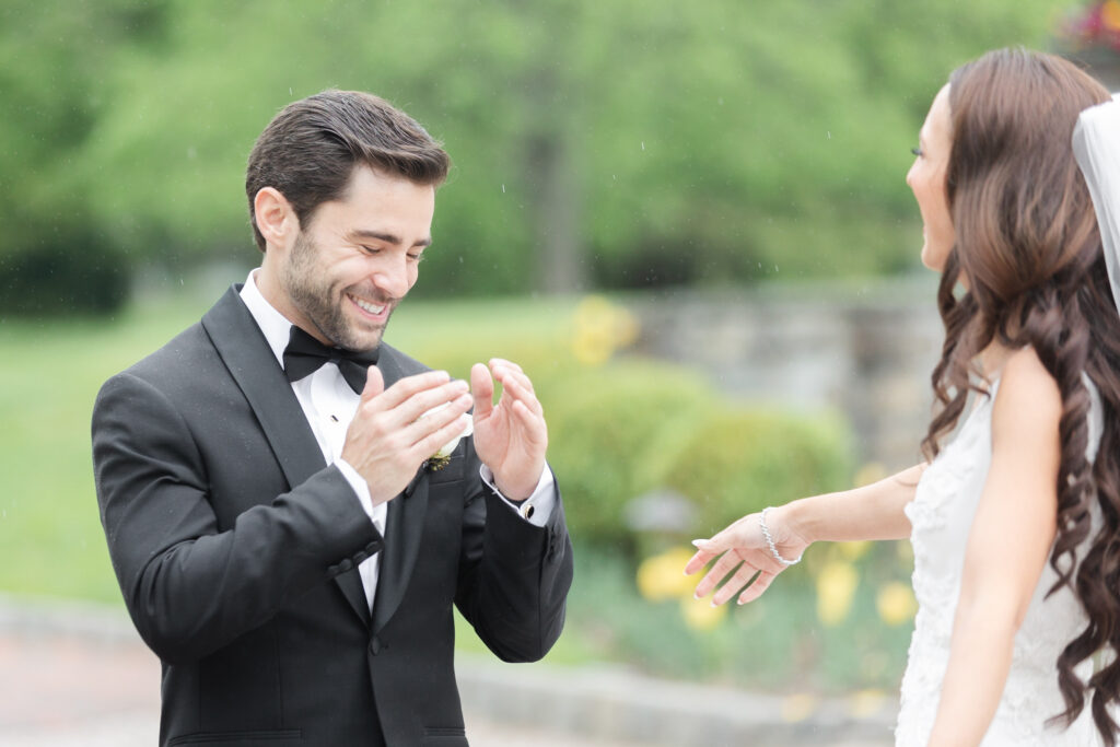 First look moment between bride and groom outside of chateau wedding venue