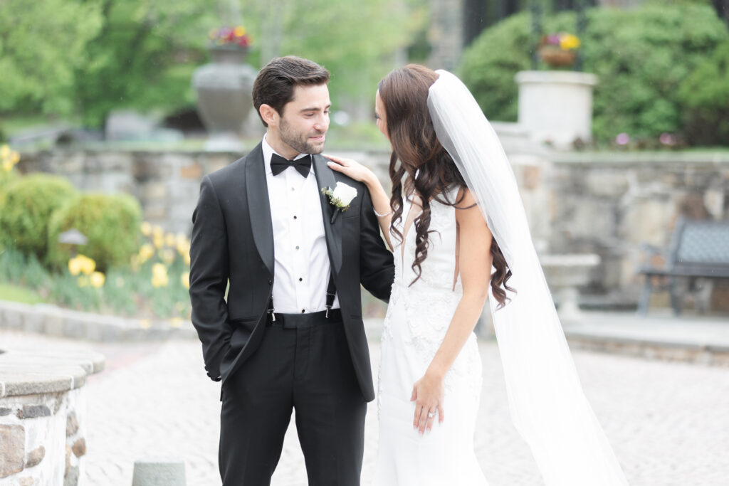 First look moment between bride and groom outside of chateau wedding venue