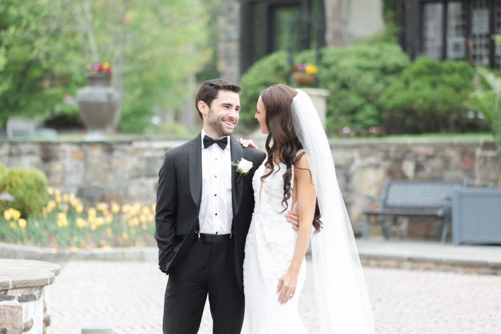 First look moment between bride and groom outside of chateau wedding venue