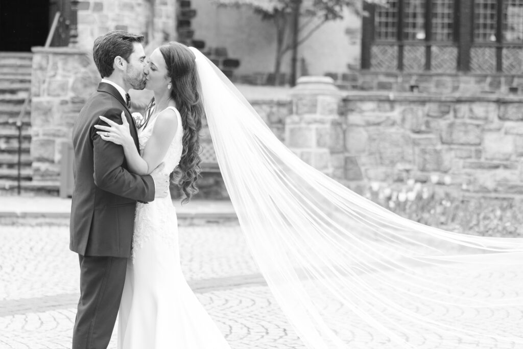 Bride and groom black and white portraits in front of New Jersey Castle Wedding venue