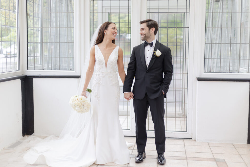 Bride and groom inside Pleasantdale Chateau Greenhouse