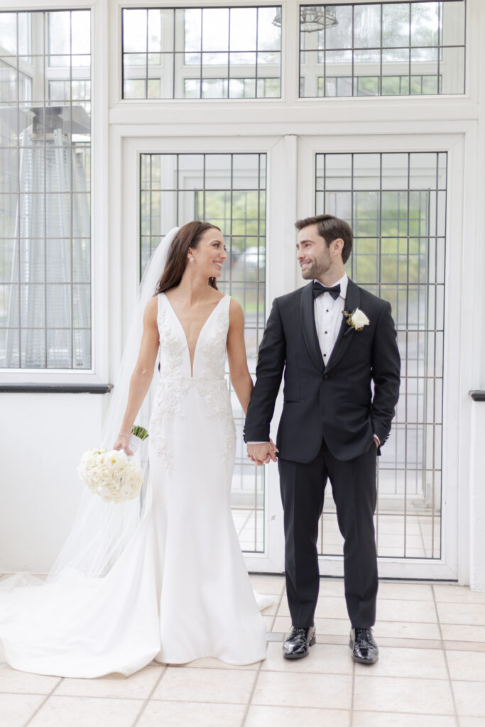 Bride and groom inside Pleasantdale Chateau Greenhouse