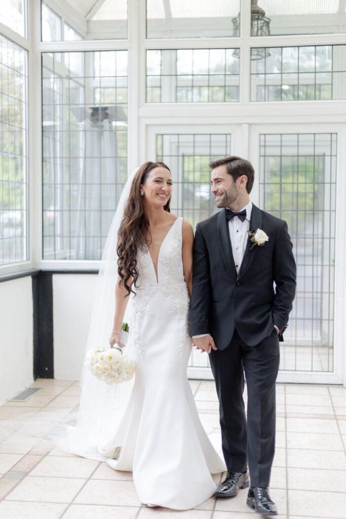 Bride and groom inside Pleasantdale Chateau Greenhouse