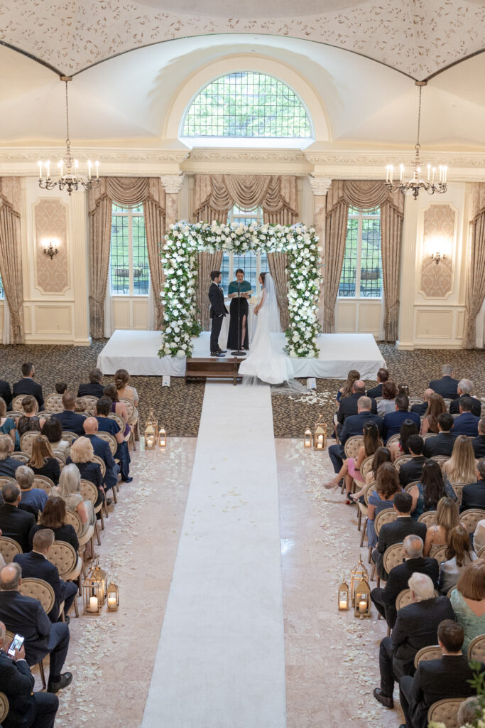 Bride and groom at wedding ceremony inside Pleasantdale Chateau