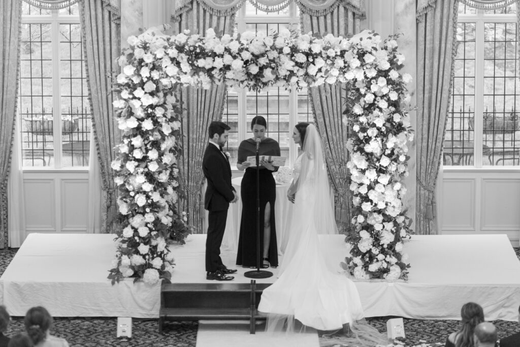 Bride and groom at wedding ceremony inside Pleasantdale Chateau