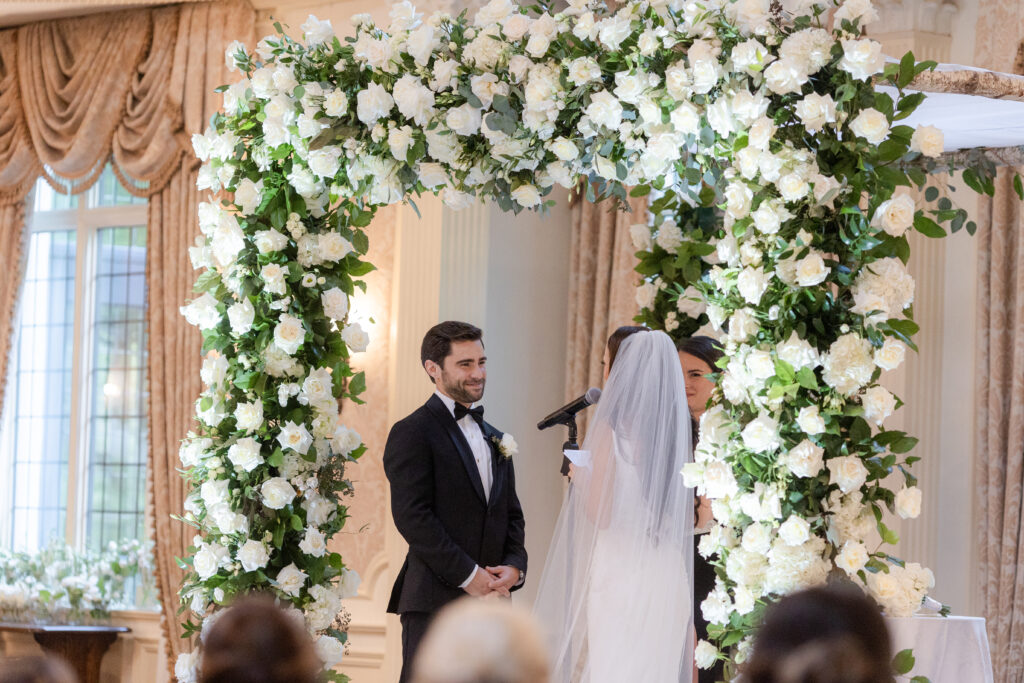 Bride and groom at wedding ceremony inside Pleasantdale Chateau