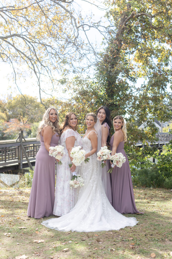 Bride and bridal party in front of Wooden Bridge at Divine Park