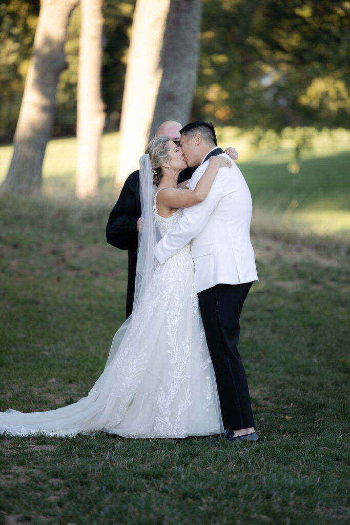 Bride and groom first kiss at wedding ceremony